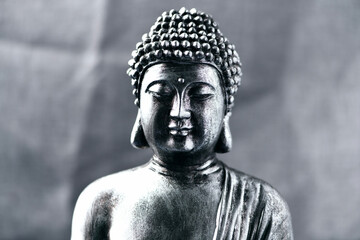 Meditating Buddha Statue on dark background. Soft focus. Close up. Copy space.	