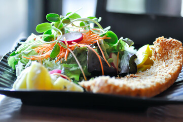 fried fish with tomato gravy and salad or fish and chips