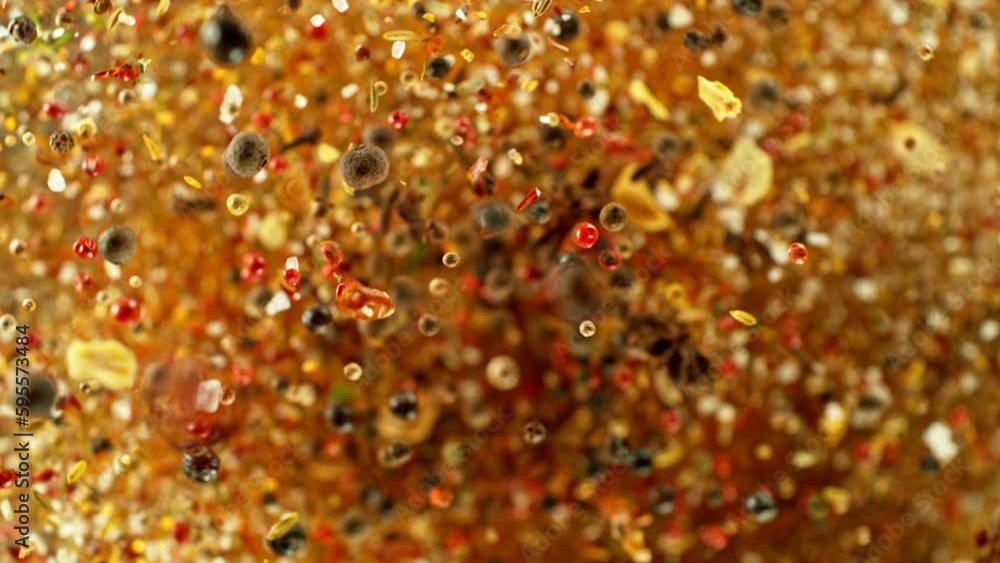 Poster super slow motion of rotating spices mix on black background. filmed on high speed cinema camera, 10