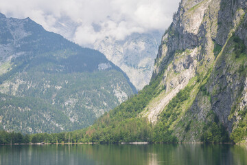 Naklejka na ściany i meble Alpine landscape with lake, forests, high mountains and steep stone walls, Konigssee, Germany