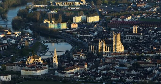 Aerial view of the medieval city of Auxerre, France. Aerial view of the city center and rooftops. The drone flies over the city at sunset. View of beautiful streets in the center of Auxerre