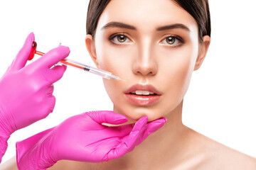 The doctor cosmetologist makes Lip augmentation procedure of a beautiful woman in a beauty...