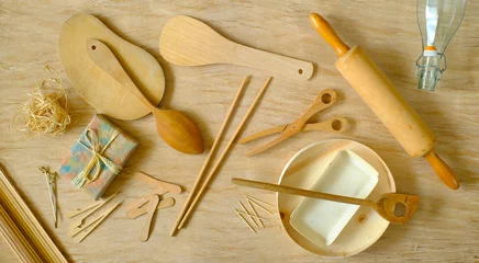 Gordijnen kitchen utensils from eco friendly materials on tablecloth made of compressed tree bark, recycling, environmental conservation concept, flat lay © Kirsten Hinte