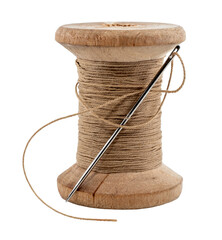 Old wooden spool of thread and needle on a white background. Sewing accessories