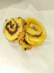 Some pieces of yellow and brown sponge cakes with white background