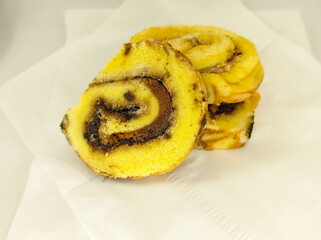 Some pieces of yellow and brown sponge cakes with white background