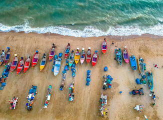 Aerial shot from a drone of a group of local fishing boats at Jomtien Beach, Pattaya, Thailand.
