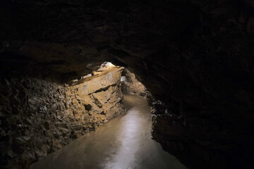 Lit passageway in dark cave