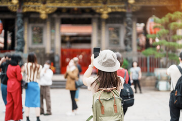 woman traveler visiting in Taiwan, Tourist with hat sightseeing in Longshan Temple, Chinese folk...