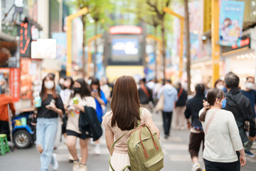 woman traveler visiting in Taiwan, Tourist with bag sightseeing and Shopping in Ximending street Market, landmark and popular attractions in Taipei city. Asia Travel and Vacation concept