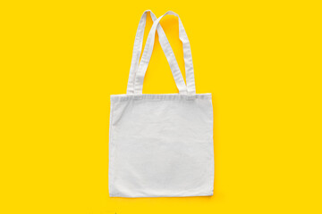 White cotton, canvas, tote, mesh bag on yellow background. Zero waste, no plastic, eco friendly shopping, recycling concept. Blank mockup shopper with place for artwork or text. Flat lay, copy space