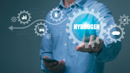 Businessman pressing icon on virtual screen with word hydrogen Green concepts, industry, nature and...