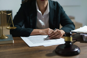 Businesswoman lawyer working and reading agreement business to signing on contract in legal office