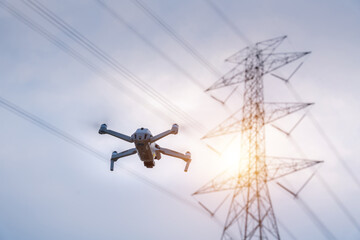A drone is flying surveying equipment of high voltage pylons to inspect aerial view equipment on...