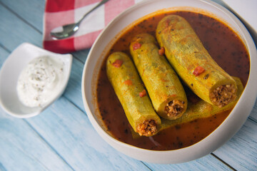 Recipe of stuffed courgette with tomato sauce, Lebanese style, Kouca Mehchi bi Banadoura, with Greek yogurt. High quality photo