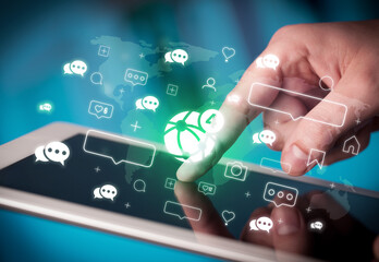 Fototapeta premium Close-up of a hand using tablet, social media concept