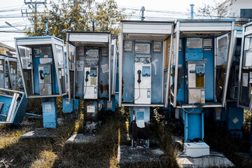 Old and dirty street phones at the city landfill