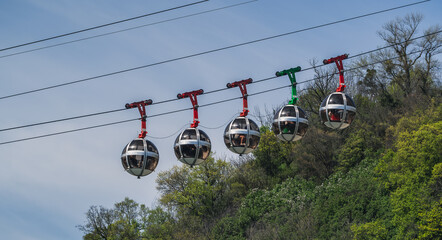 Gondola bubbles against the blue sky. Cable car taking tourists to Fort de La Bastille in Grenoble,...