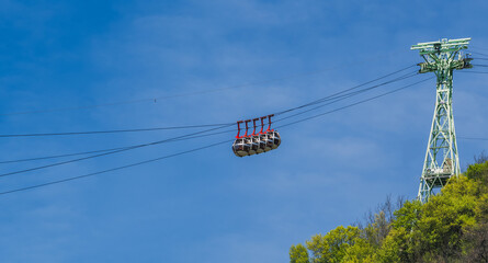 Gondola bubbles against the blue sky. Cable car taking tourists to Fort de La Bastille in Grenoble,...