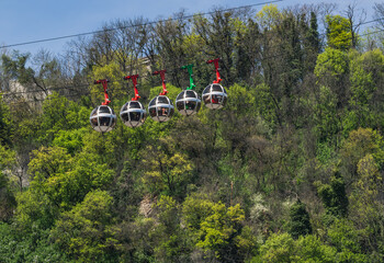 Gondola bubbles against the blue sky. Cable car taking tourists to Fort de La Bastille in Grenoble,...