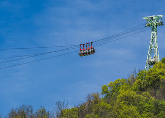 Gondola bubbles against the blue sky. Cable car taking tourists to Fort de La Bastille in Grenoble,...