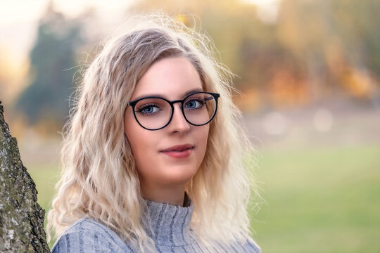 Portrait of young blond woman in glasses
