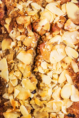 Natural whole wheat bread with almond nuts and seeds, top view. Close-up baking. Stylish design of natural products and sugar-free bread