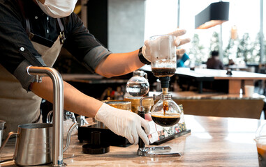 Barista preparing coffee drink at the big shopping mall
