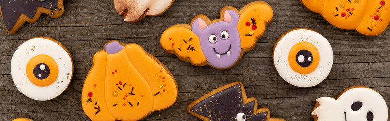Delicious halloween homemade cookies of various shapes on old wooden table