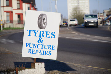 Tyre and puncture repairs sign outside a garage