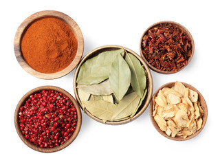 Bowls with different spices on white background, top view