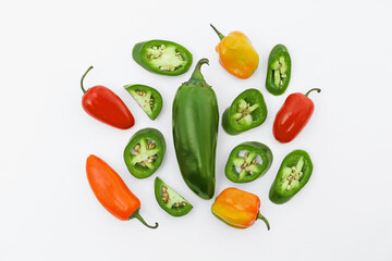 Different hot chili peppers on white background, flat lay