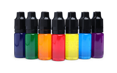 Bottles with different food coloring on white background