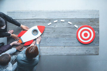 Business people launch rocket
