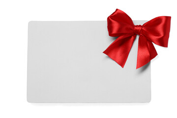 Blank gift card with red bow isolated on white, top view