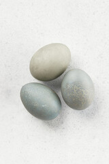 Fototapeta na wymiar Eggs dyed with natural dyes on a gray background. Easter celebration concept