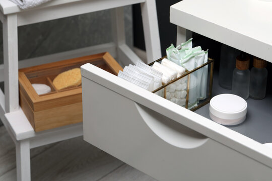 Storage of different feminine and personal care products in drawer indoors