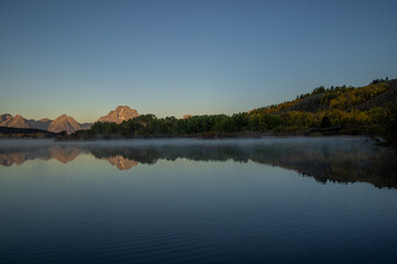 Beautiful Sunrise Landscape Reflection in the Tetons in Autumn