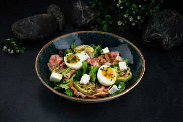 Salad with bacon, egg, zucchini, feta cheese and lettuce.
