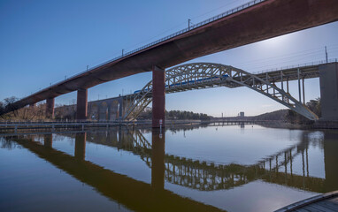 Backlight train bridges in the bay Årstaviken, a tranquil early sunny spring day in Stockholm