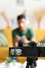afro boy playing video games while filming for his video blog