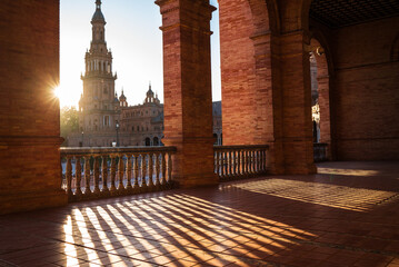 The Plaza de España galleries lited up with evening sunlight making magic shadows. North tower view on Spain Square, Andalusia, South Spain.