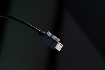 Black HDMI cable in dark background