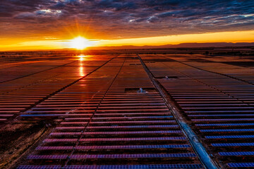 A solar power farm with sunrise over the mountain, overhead aerial view taken with a drone in Elora Tennessee