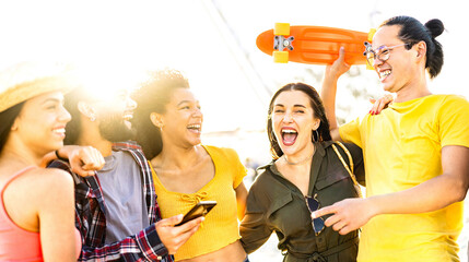 Beach life style concept with young people having fun together at spring break festival - Happy guys and girls students cheering at sunset on vacation days - Bright vivid filter with sunshine halo