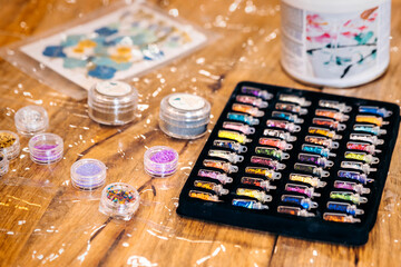 Jewelry workshop with epoxy resin. Jewelry decoration in sealed glass jars.
