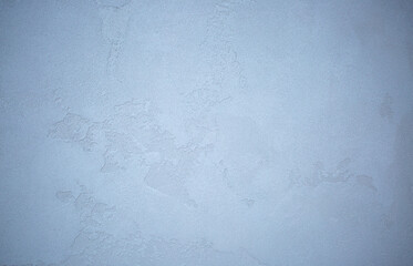 Gray background of decorative plaster with abstract spots. Unusual silver wall texture with beautiful patterns, creative surface background. Dressing coating for building cladding.