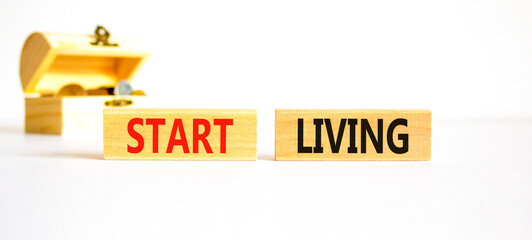 Start living symbol. Concept words Start living on beautiful wooden block. Beautiful white table...