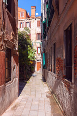 Fototapeta na wymiar Old narrow street in the historical part of Venice.