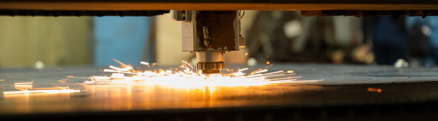 CNC machine. Laser cutting of metal. Sparks. Widescreen. 